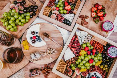 Appetizers table with brie cheese, fruit and snacks. Cheese and meat variety board in Mexico Latin America