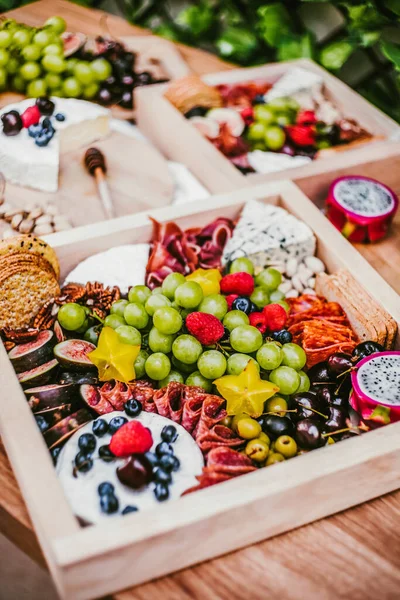 Appetizers table with brie cheese, fruit and snacks. Cheese and meat variety board in Mexico Latin America