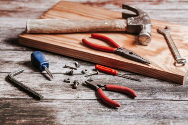 Set of tools on rustic and vintage table for handicraft or construction