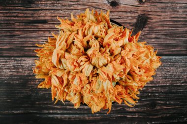 squash blossom or Zucchini flowers on a old wooden table Mexican food in Mexico Latin America