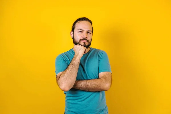 Portrait of young hispanic man with positive expression on yellow background in Mexico Latin America