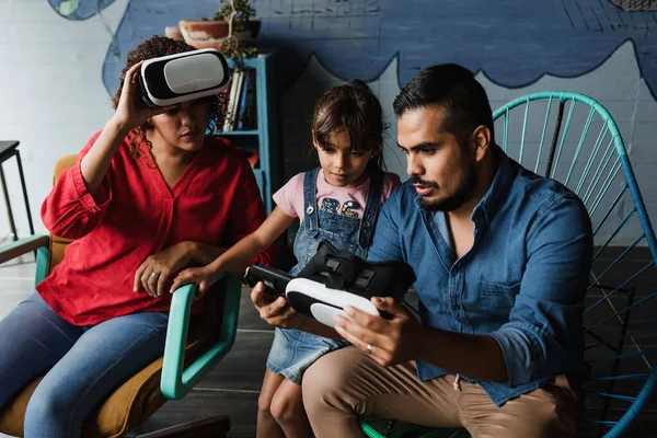 hispanic father playing virtual reality game with his family and daughter at home in Mexico Latin America