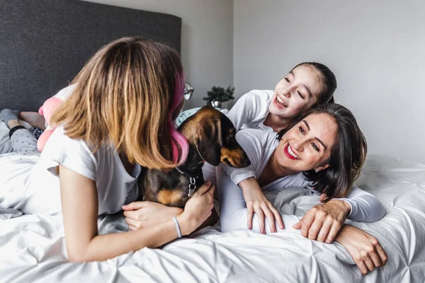 Hispanic Happy Family Women Mother Daughter Laughing Playing Dog Bed — Foto de Stock