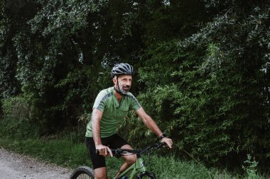 hispanic Senior man on his mountain bike cycling outdoors in Mexico Latin America 