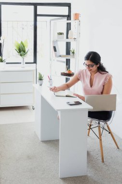 hispanic business woman working in her desk at office in Mexico Latin America