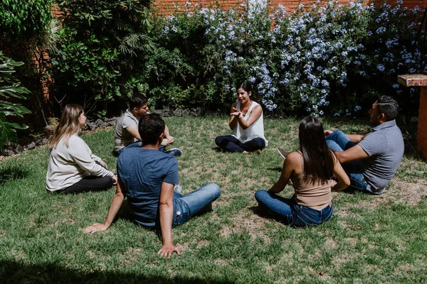 Hispanic Young People Seated Circle Grass Participating Group Therapy Session — Φωτογραφία Αρχείου