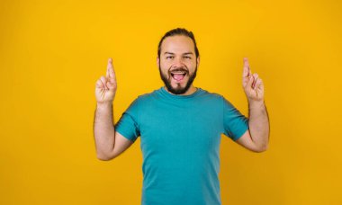 Portrait of young hispanic man with positive expression on yellow background in Mexico Latin America