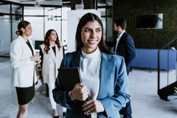 stock image young latin business woman portrait with her colleagues at background at the office in Mexico Latin America, hispanic people team