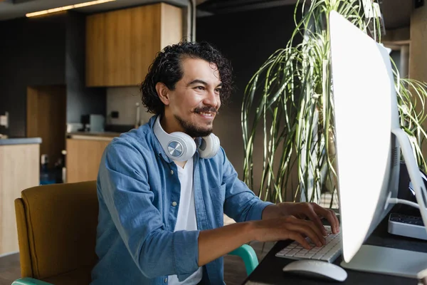 Young latin Man Working from Home on Desktop Computer or Creative Designer on home office in Mexico Latin America, hispanic people