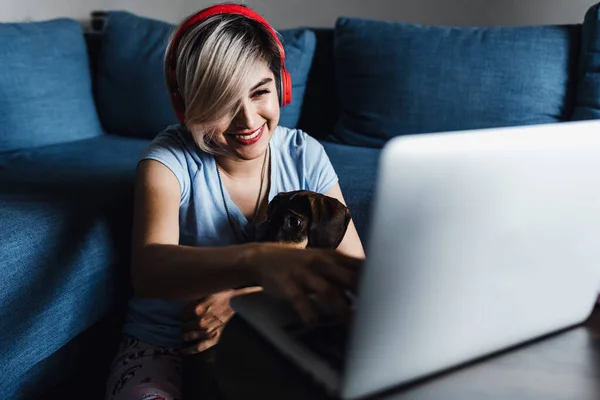 latin young woman working and using laptop with dog pet at home in home office or freelance concept in Mexico Latin America, hispanic people
