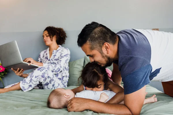 stock image latin family with children having fun together on bed at home in Mexico Latin America, hispanic people