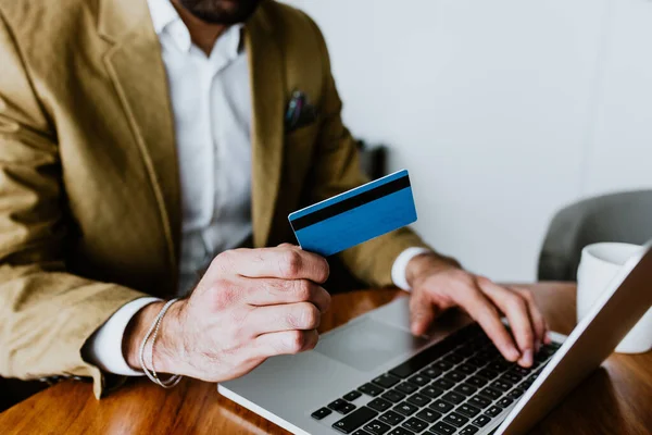 stock image hands of businessman holding credit cards, pay for goods and services, make purchases on online shopping sites and make payments Online shopping concept in latin America