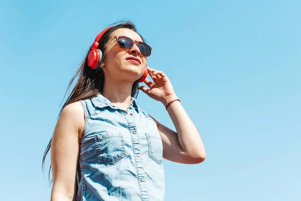 stock image young latin woman listening music with smartphone and wireless headphones in Mexico Latin America, hispanic people
