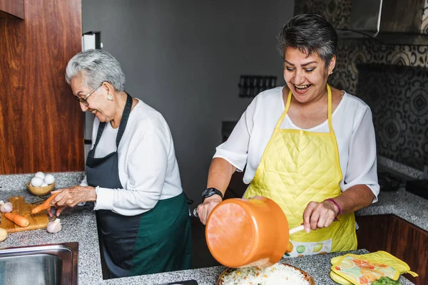 latin women grandmother and daughter cooking at home kitchen in Mexico Latin America, hispanic people