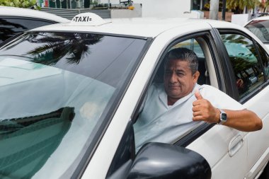 Latin Amerika 'da Mexico' da şehir sokağında arka planda arabası olan Latin taksi şoförü kıdemli bir adamın portresi. Latin yetişkin insanlar.