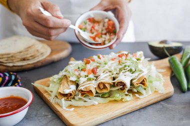 Mexican tacos dorados called flautas with chicken, traditional fried food in Mexico Latin America clipart