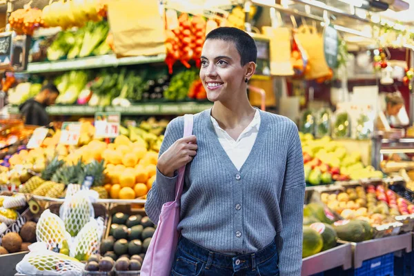 stock image hispanic young woman with skinhead or short hair shopping vegetables on traditional market or grocery 