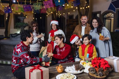 Mexican Posada, Hispanic family Singing carols in Christmas celebration in Mexico Latin America clipart