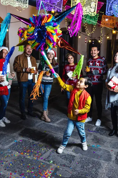 stock image Hispanic family breaking a pinata at traditional mexican posada celebration for Christmas in Mexico Latin America