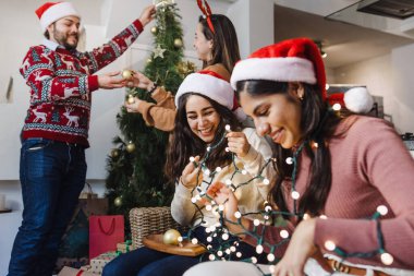 İspanyol arkadaşlar Meksika 'da Noel ağacına Noel ışıkları koyuyorlar.