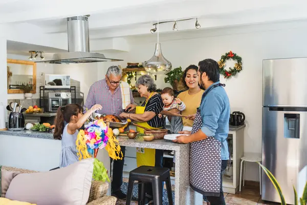 Latin family cooking together for Christmas dinner at home in Mexico Latin America, hispanic people preparing food in holidays