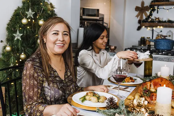 Latin woman with family having Christmas dinner at home in Mexico Latin America, hispanic female