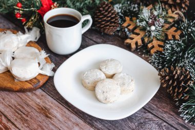 Geleneksel Noel polvoronları, nevaditolar, tabakta mantecados ve bayram için bir fincan kahve.