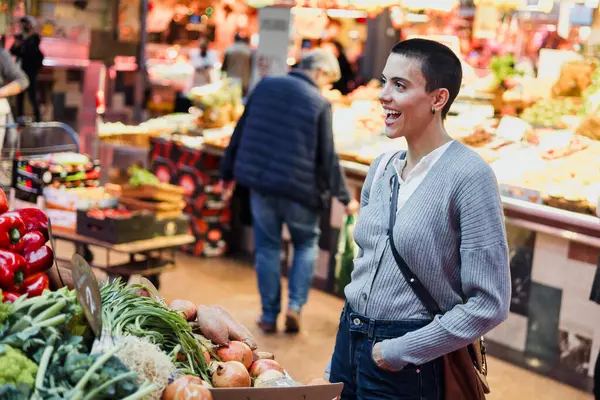 stock image hispanic young woman with skinhead or short hair shopping vegetables on traditional market or grocery 