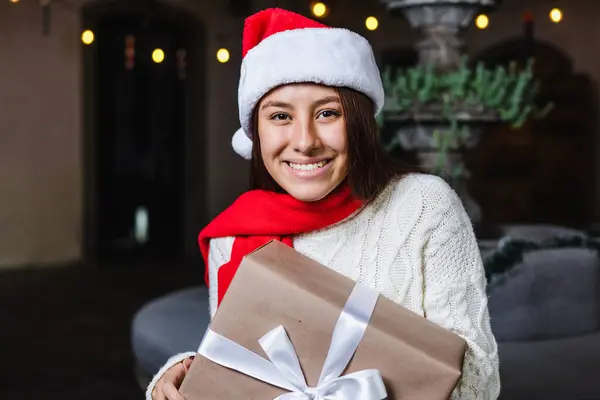 stock image Hispanic young woman portrait holding a gif box at traditional posada party for Christmas in Mexico Latin America