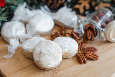 Baking polvorones traditional for Christmas season, or called nevaditos, mantecados or sweet cookies on plate for holidays. recipe and ingredients clipart