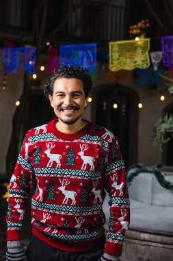 Mexican man at traditional posada party for Christmas celebration in Mexico Latin America, holidays and Christmas eve clipart