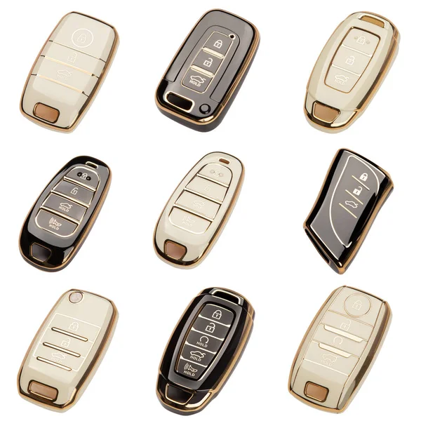 Car keys lie in different poses on a white background. Black key rings from the car alarm are located on a white background.