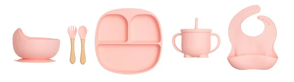 Farklı renklerde silikondan yapılmış ve beyaz arka planda çekilmiş çocuklar için yemekler. Tabaklar, kaşıklar, bardaklar..