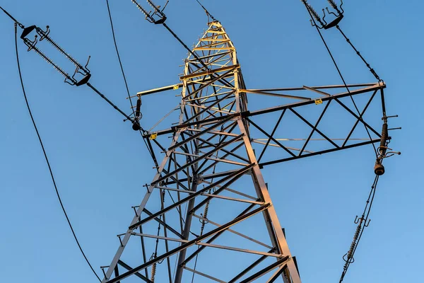 stock image Electric station for supplying electricity to city, village. High voltage electric tower. Close-up. Power line against blue sky.