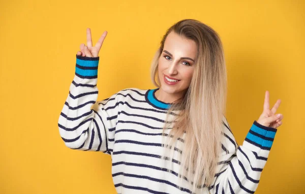 Playful Woman Gesturing Peace Sign Fingers Isolated Yellow Background Cheerful — Stock Photo, Image