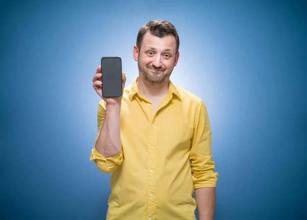 Furious Man Talks Mobile Phone Blue Background Dresses Yellow Shirt — Stock Photo, Image