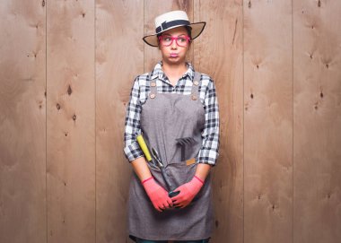 Stüdyoda genç bahçıvan kadını somurtuyor. Memnun olmayan genç bahçıvan kadın. Stüdyo çekimi