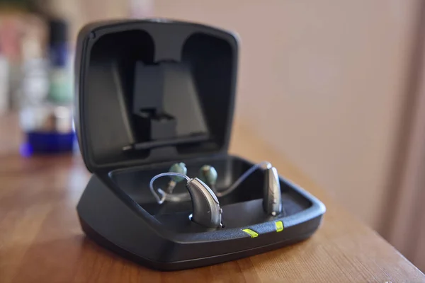 Close Up Of Wireless Hearing Aid Or Device From Charging Case At Home
