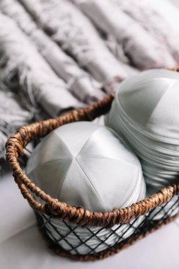 İpeksi baş örtüleri dokuma sepetinde sergilenir, pürüzsüz dokularını ve zarif tasarımlarını vurgular..