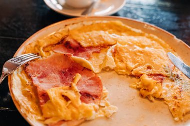 Sabahları sıcak bir kafe atmosferinde jambon dilimli doyurucu bir omlet..