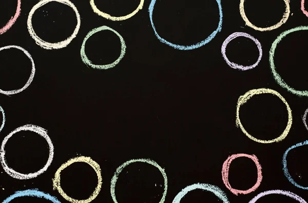 colored circles drawn on chalkboard