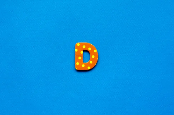 letter d on blue paper background