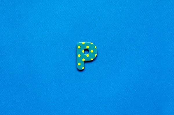 stock image letter p on blue paper background 