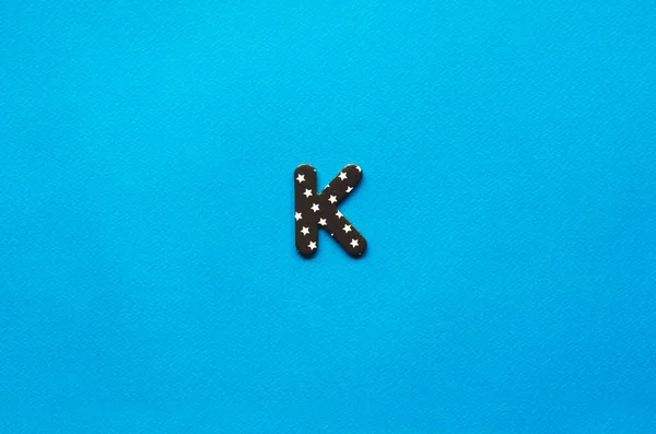 letter k on blue paper background