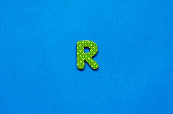 letter r on blue paper background