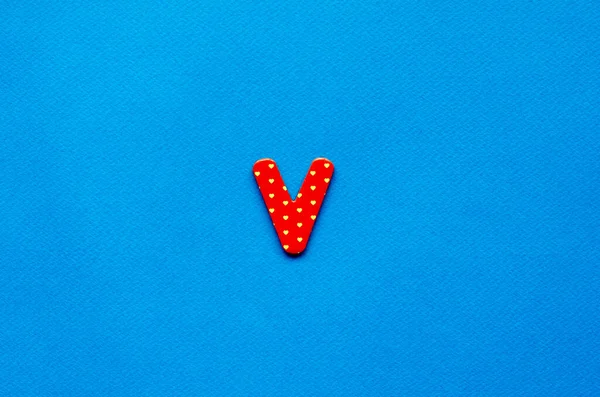 letter v on blue paper background