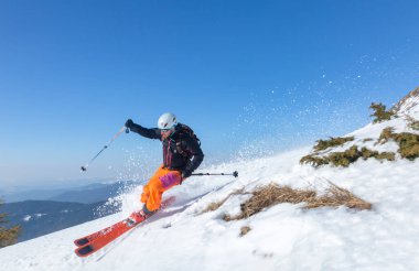 Marmaros, Karpatlar, UKRAINE - 15 Mart 2021: Yüksek dağlarda güneşli bir günde kayak yapan kayakçı