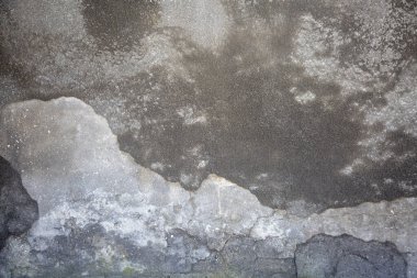 Gray concrete cracked wall of an old house background