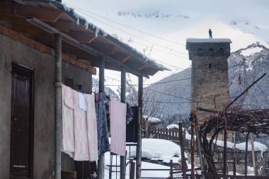 A man on a tower among the old ruins of the Svan city of Mestia, Svaneti
