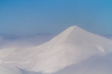 Sunny and windy winter day in the mountains. Hoverla peak, Chornohora, Carpathian Mountains, Ukraine